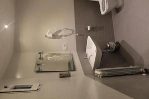 a bathroom with a toilet and a mirror at Pensión Manoli in Bilbao
