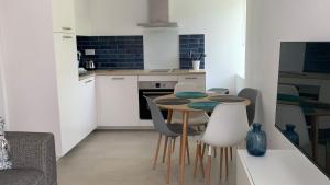 - une cuisine avec une table et des chaises dans la chambre dans l'établissement Résidence Casa Olea - Studio - T2 - T3, à Cauro