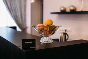 a glass bowl of fruit sitting on top of a table at Azhur Hotel in Tambov