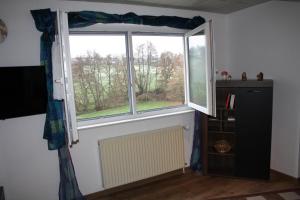 a window in a room with a radiator in front of it at Chiaras Ferienwohnung in Heusweiler