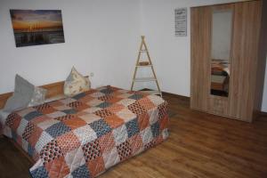 a bedroom with a bed and a ladder on the wall at Chiaras Ferienwohnung in Heusweiler