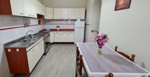 a kitchen with a table with a vase of flowers on it at Casa Arianna in Avella