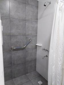 a bathroom with a shower with a shower curtain at Casa Sarmiento in San Francisco del Monte de Oro