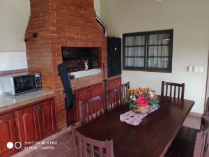 a kitchen with a table and a brick fireplace at Casa Quinta in Puerto Rico