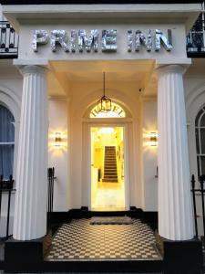 a front entrance to a store with columns at Prime Inn in London