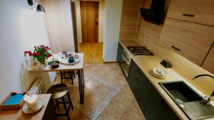 a small kitchen with a small table and a stove at Mikołowski Sen in Mikołów