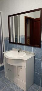 a bathroom with a white sink and a mirror at CASA DAS PEDREIRAS in Peso da Régua +25 photos