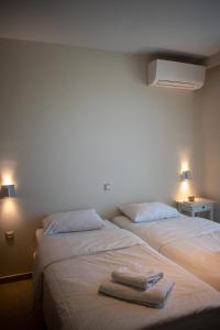 two beds sitting next to each other in a room at Greek Villas Justine View Beach in Kyllini