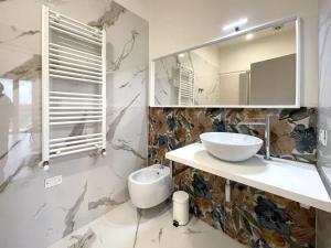 a bathroom with a sink and a mirror at Villa Pensione Mercedes in Sirmione