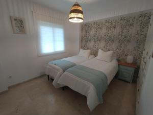sypialnia z łóżkiem i lampką w obiekcie El Mirador de Estepona w mieście Estepona +28 zdjęć