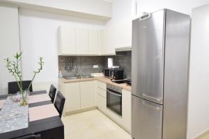 a kitchen with a stainless steel refrigerator at acropolis super cosy apartment in Athens