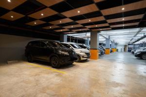 a parking garage with several cars parked in it at Cordela Suites Tasikmalaya in Tasikmalaya