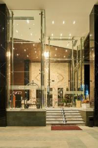 a lobby of a building with stairs in front at Cordela Suites Tasikmalaya in Tasikmalaya +91 photos