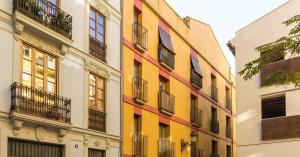 a brightly colored building with balconies on a street at BET Apartments - Tramontana Apartments in Valencia