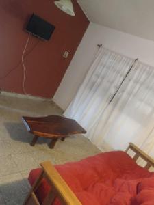 a room with a bed and a table and a window at LA CASA in Villa Anizacate