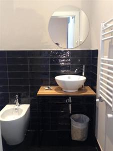 ein Bad mit einem Waschbecken und einem Spiegel in der Unterkunft Hotel Vagabond in Riccione