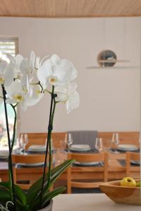 um vaso de flores brancas sentado numa mesa em Holiday Home Znojmo w/ Wellness & Wine em Znojmo