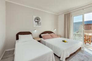 a bedroom with two beds and a balcony at Apartmani Vico in Herceg-Novi +38 photos
