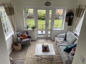 a living room with a couch and a table at Number 5, Southwold in Southwold