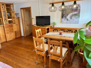 a dining room with a table and a tv at Biberhof im Mühlviertel 