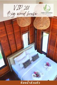 a bed in a big wood house with two plates on it at สะปัน กลางนา คาเฟ่ Sapan Klang Na Cafe in Ban Huai Ti +44 photos