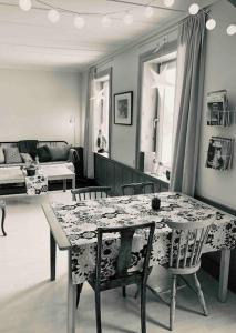 a dining room with a table and chairs and a living room at Appartement in Jämtland bij Gusto Stables ... in Föllinge