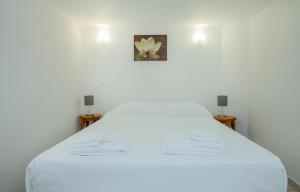 เตียงในห้องที่ B21 - Oliveira Cozy Flat