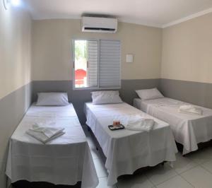 Postelja oz. postelje v sobi nastanitve Hotel Barão Ribeirão