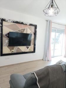 a living room with a flat screen tv on a wall at Sweet Home Annalisa in Ortona
