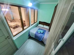 a small bedroom with a bed and a window at Sunny Apartment close to Erebuni mall in Yerevan