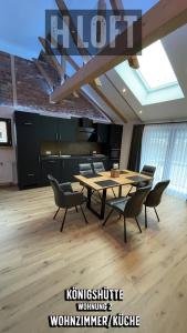 a dining room with a table and chairs in a room at H-Loft Style Apartments in Bad Lauterberg