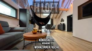 a living room with a hammock hanging from the ceiling at H-Loft Style Apartments in Bad Lauterberg