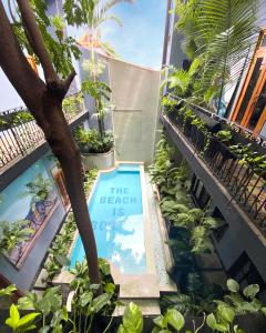 a sign in the middle of a building with plants at AmazINN Places Casco Viejo Pool and Rooftop V in Panama City