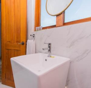 biała umywalka w łazience z lustrem w obiekcie AmazINN Places Casco Viejo Pool and Rooftop XI w Panamie +15 zdjęć