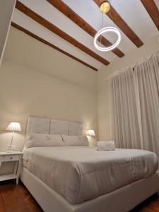 a bedroom with a white bed and a white ceiling at Catalina Suites in Valencia