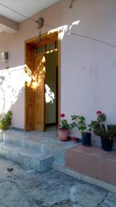 a front door of a house with potted plants at Sonce - Tirana in Tirana