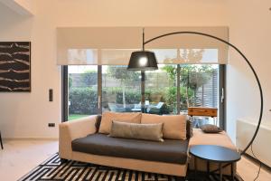 a living room with a couch and a table at The Lop Athens Holidays Luxury Suites in Athens