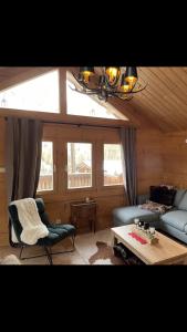 a living room with a couch and a table at Le Chalet d’Andrea in Vars