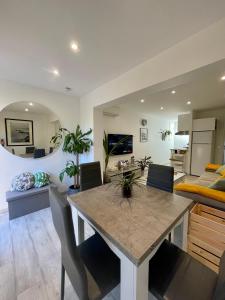 a dining room with a table and a living room at A1 LA PLAGE D'OR in Le Lavandou