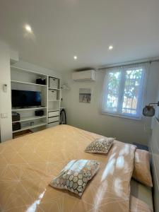 a bedroom with a large bed with two pillows at A1 LA PLAGE D'OR in Le Lavandou