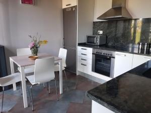 a kitchen with a table and a stove top oven at NAVASA in Navasa