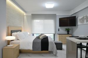 A bed or beds in a room at The Lop Athens Holidays Luxury Suites