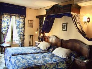 1 dormitorio con 1 cama con edredón azul en Chez Lydia - Osez la vie de chateau ! Pont du Gard, Uzès en Remoulins