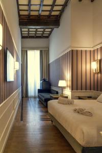 a bedroom with a large bed and a couch at Il Campo Marzio in Rome
