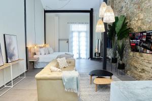 a living room with a couch and a bed at AmazINN Places Rooftop and Design Pool IV in Panama City +13 photos