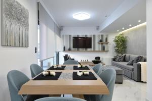 A television and/or entertainment centre at The Lop Athens Holidays Luxury Suites