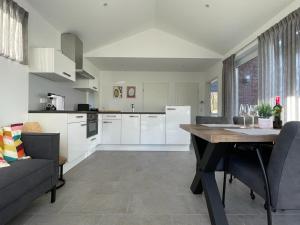 a kitchen and living room with a table and chairs at Haus Else in Schüttorf