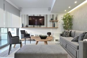 A television and/or entertainment centre at The Lop Athens Holidays Luxury Suites