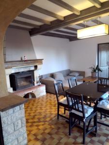 a living room with a table and a fireplace at La Coste Blanque in Montaut