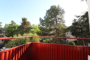 a red bridge with trees in the background at Stockholm Apartment Hammarbyhöjden in Stockholm